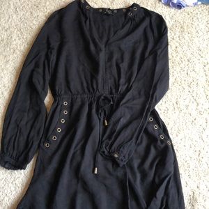 Black mini dress with gold details and pockets